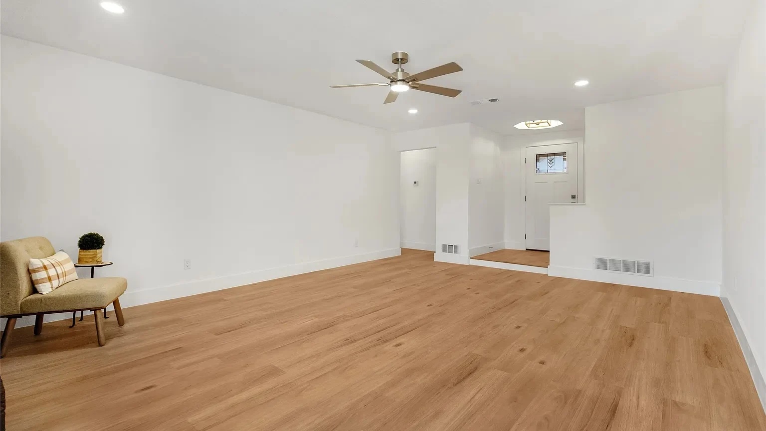Newly installed wide plank flooring running through an open Lantern living room in Dallas-Fort Worth