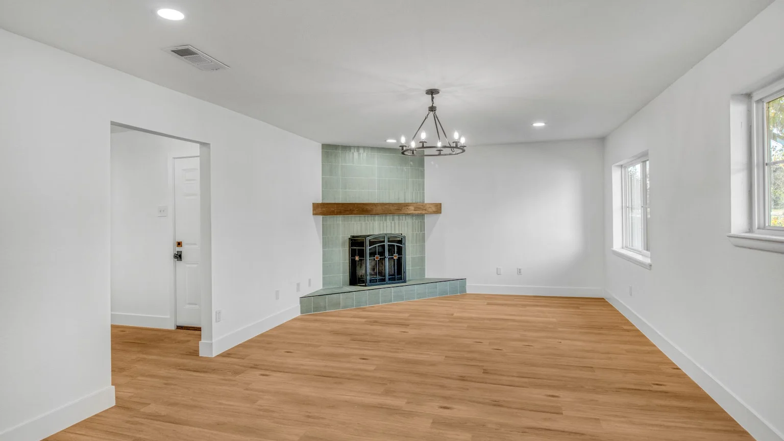 Freshly painted Lantern living room with clean white walls, a tiled fireplace, and oak flooring