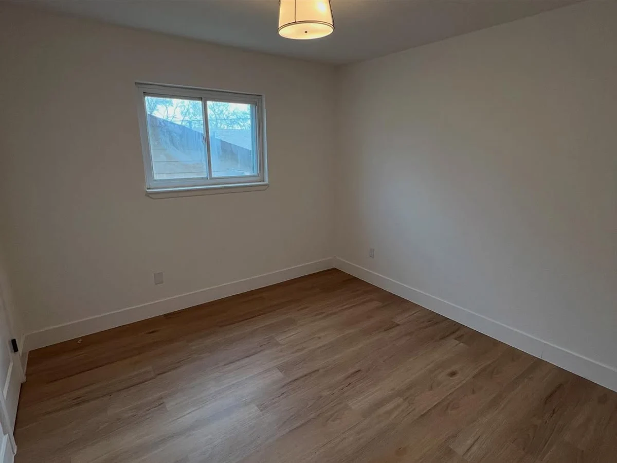 Freshly painted bedroom with white walls and new flooring